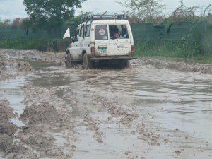 The car filled with the mothers finds it's way in the camp for the funeral outside